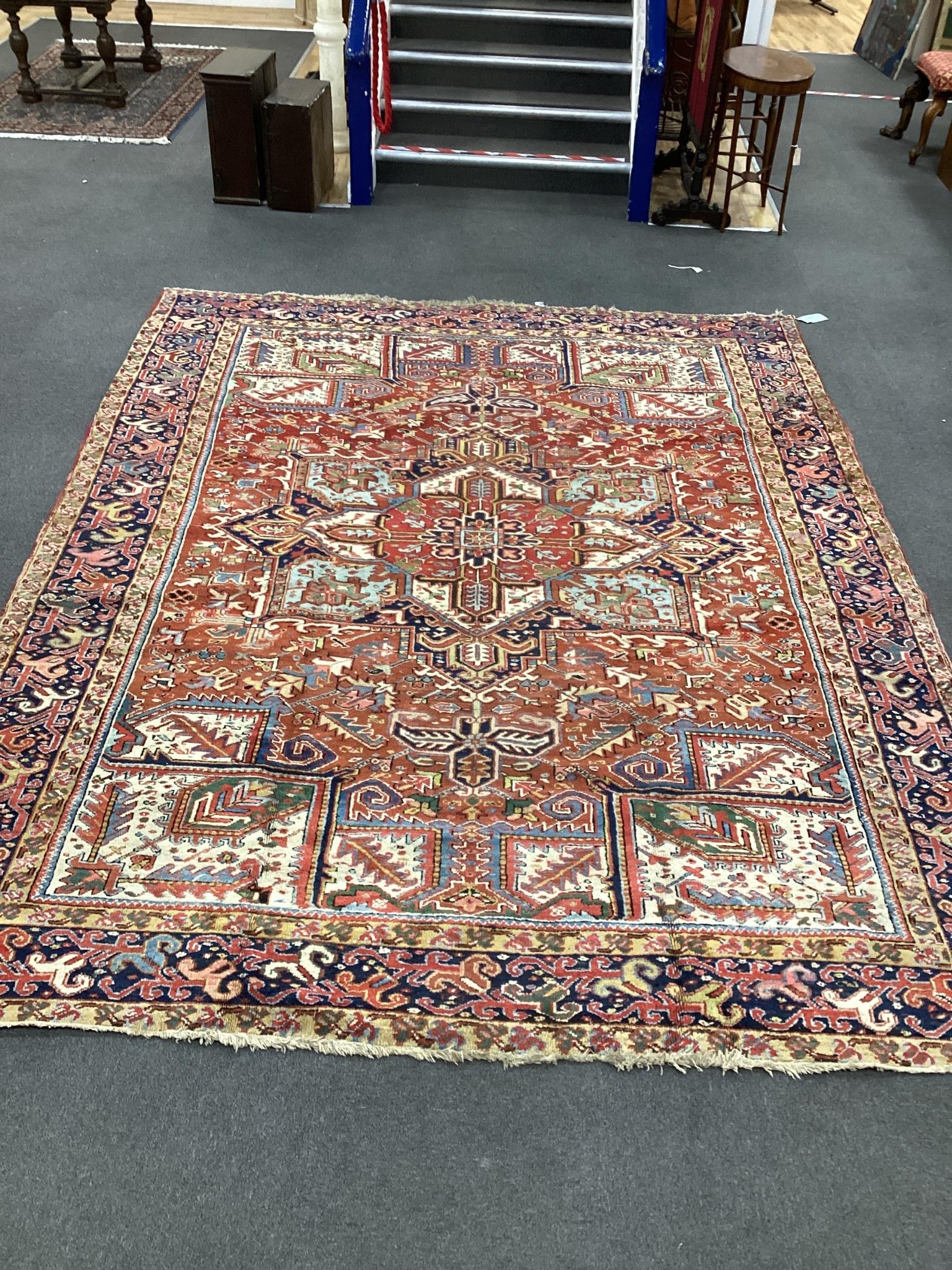 An early 20th century Heriz red ground carpet, 336 x 250cm